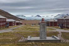 Lenin statue looking over village square toward glacier