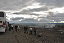 group of people taking pictures of environmental impacts from nickle smelter